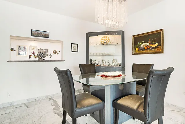 a dining room with furniture and window