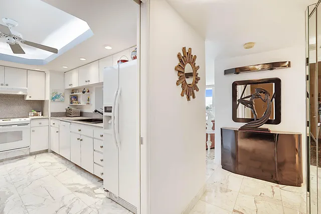 a kitchen with a sink stove and white cabinets