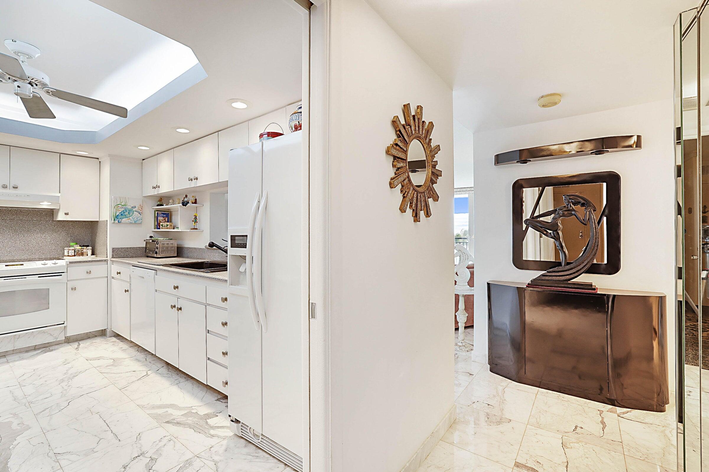 1149 Hillsboro Mile, Unit 310 Hillsboro Beach, FL 33062 - Photo 16 of 33 a kitchen with stainless steel appliances kitchen island a white cabinet and a granite counter tops