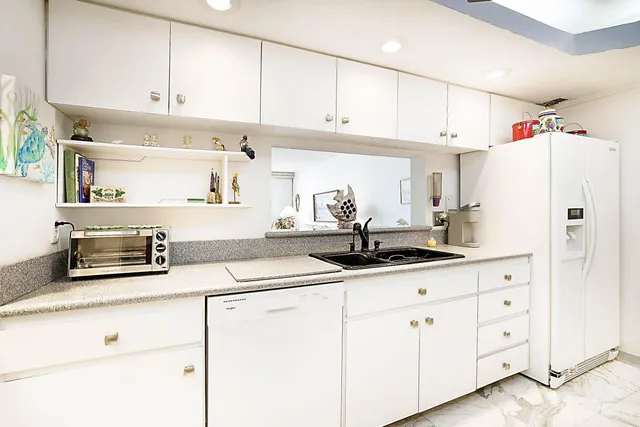 a dining room with kitchen island a table and chairs