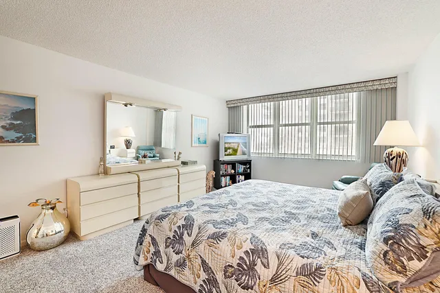 a bedroom with a bed and a night stand