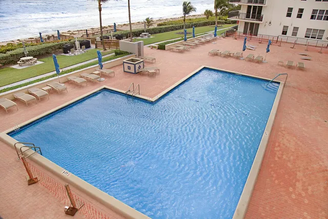 swimming pool view with a seating space