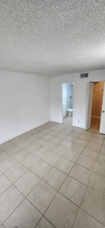 a bathroom with a granite countertop sink a toilet and a mirror