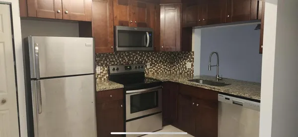 a kitchen with a refrigerator sink and microwave