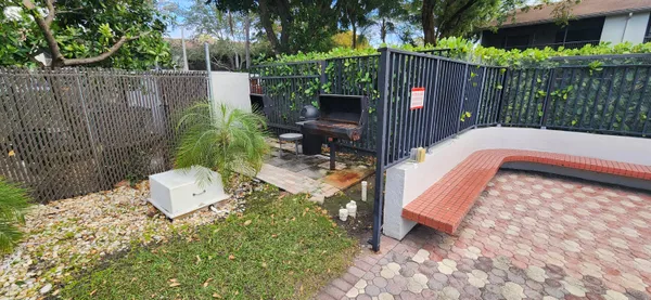 a view of a swimming pool with outdoor seating and plants