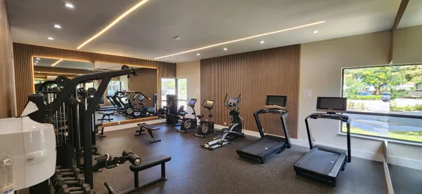 a kitchen with stainless steel appliances a refrigerator a sink and wooden cabinets