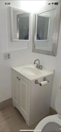 a bathroom with a sink toilet and mirror