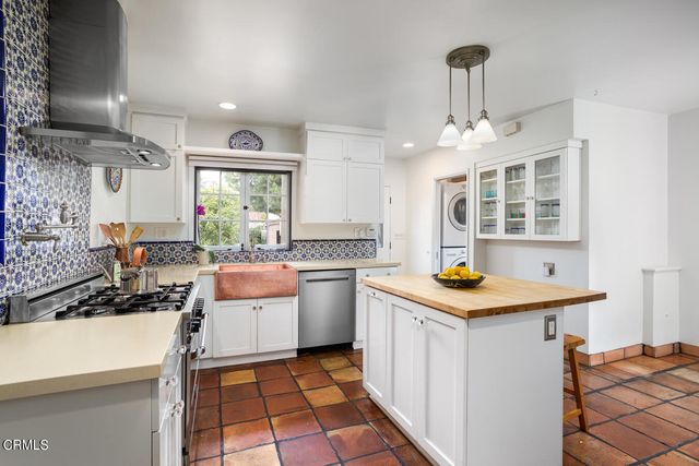 a kitchen with a sink stove and cabinets
