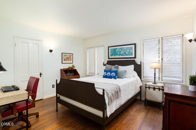 a bedroom with a bed a table and chair