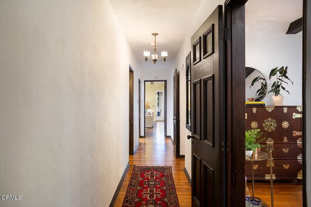 a spacious bedroom with a bed a dresser and a window