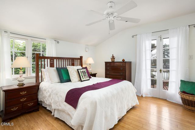 a bedroom with a bed and a wooden floor