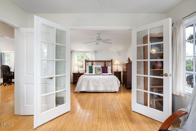 a bedroom with a bed and ceiling fan