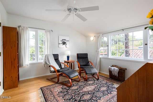 a view of a balcony with wooden floor and outdoor seating