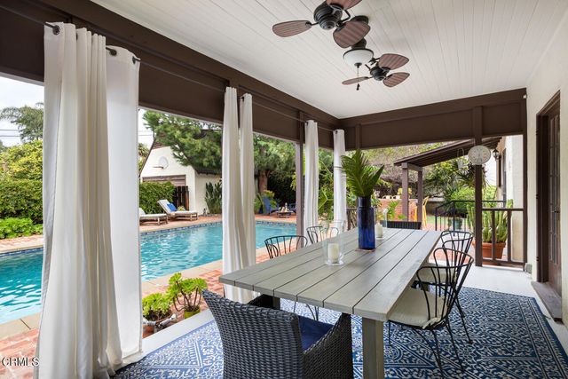 a house view with a sitting space and garden