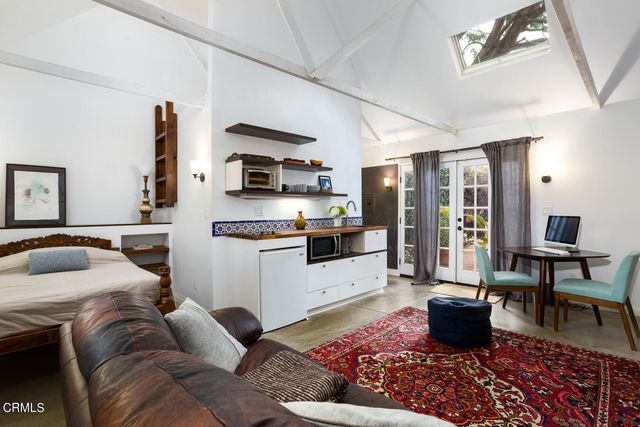 a living room with furniture a rug and a flat screen tv