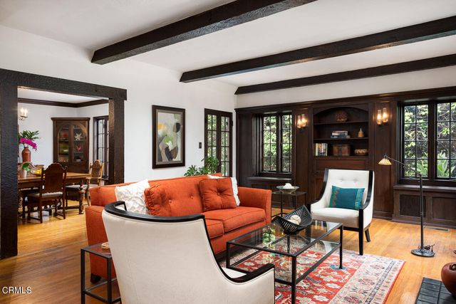 a living room filled with furniture and floor to ceiling windows