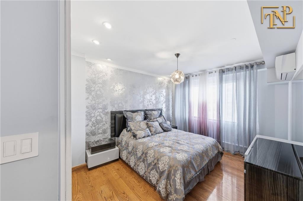 2854 Brighton 4th Street, Unit 6 Brooklyn, NY 11235 - Photo 11 of 19 a bedroom with a bed and a window