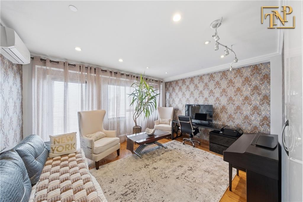 2854 Brighton 4th Street, Unit 6 Brooklyn, NY 11235 - Photo 12 of 19 a living room with furniture and a flat screen tv