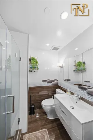 a spacious bathroom with a double vanity sink a mirror and a bathtub