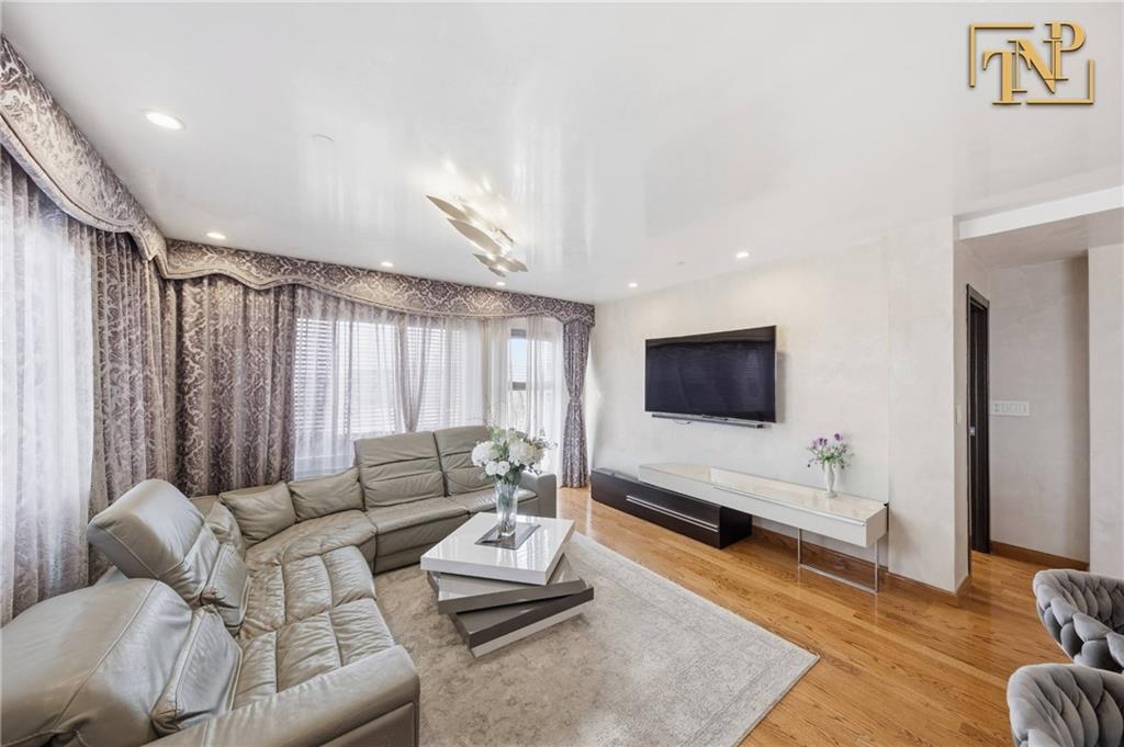 2854 Brighton 4th Street, Unit 6 Brooklyn, NY 11235 - Photo 3 of 19 a living room with furniture and a flat screen tv