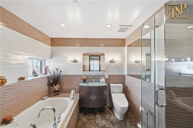 a bathroom with a granite countertop toilet a sink a tub and mirror
