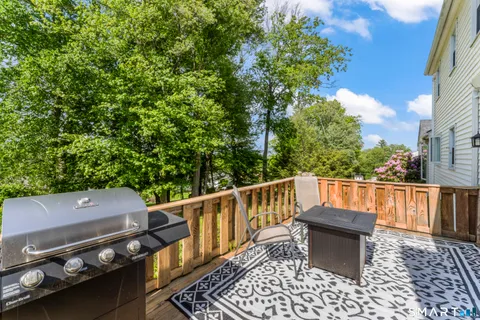 a view of a roof deck with couches and wooden floor