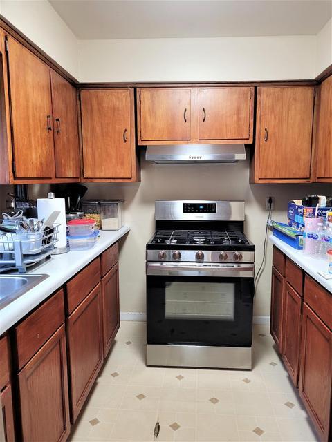 1718 Roosevelt Place Gary, IN 46404 - Photo 6 of 18 a kitchen with stainless steel appliances granite countertop a stove a sink and a microwave