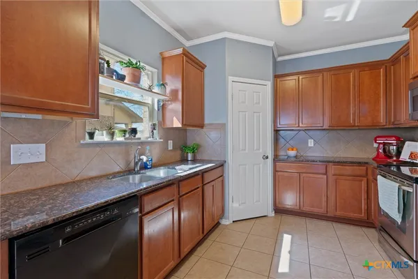 a kitchen with stainless steel appliances granite countertop a sink stove and cabinets