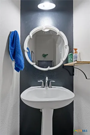 a bathroom with a sink and mirror