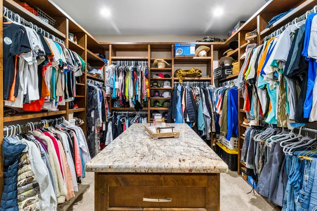 a view of walk in closet with clothes