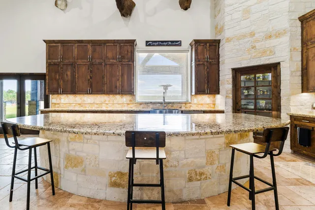a kitchen with a sink cabinets and window