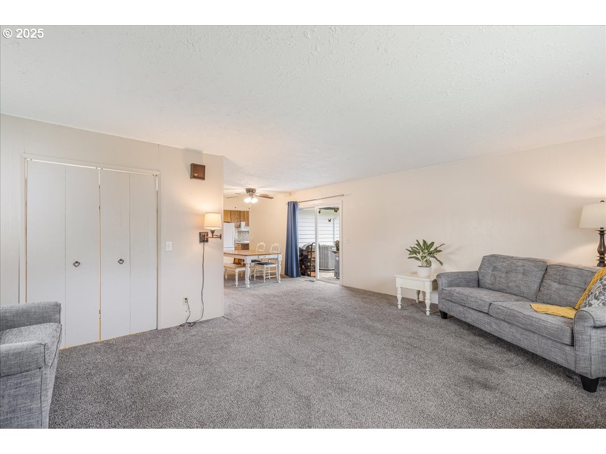 2604 Southeast 176th Place Portland, OR 97236 - Photo 14 of 27 a living room with furniture and white walls