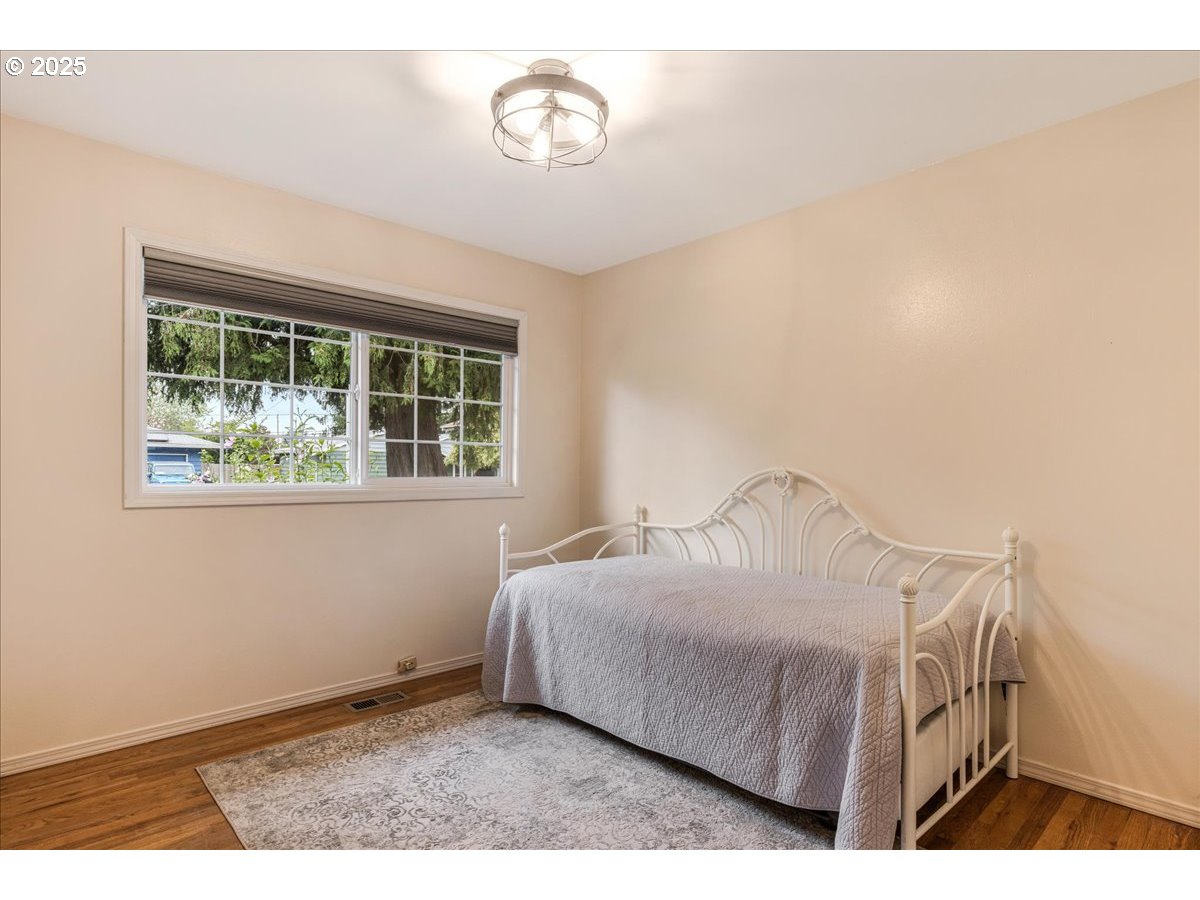 2604 Southeast 176th Place Portland, OR 97236 - Photo 19 of 27 a bedroom with a bed and a window