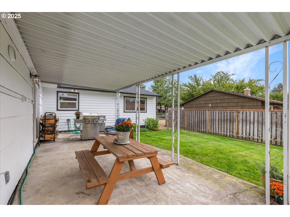 2604 Southeast 176th Place Portland, OR 97236 - Photo 23 of 27 a backyard of a house with table and chairs