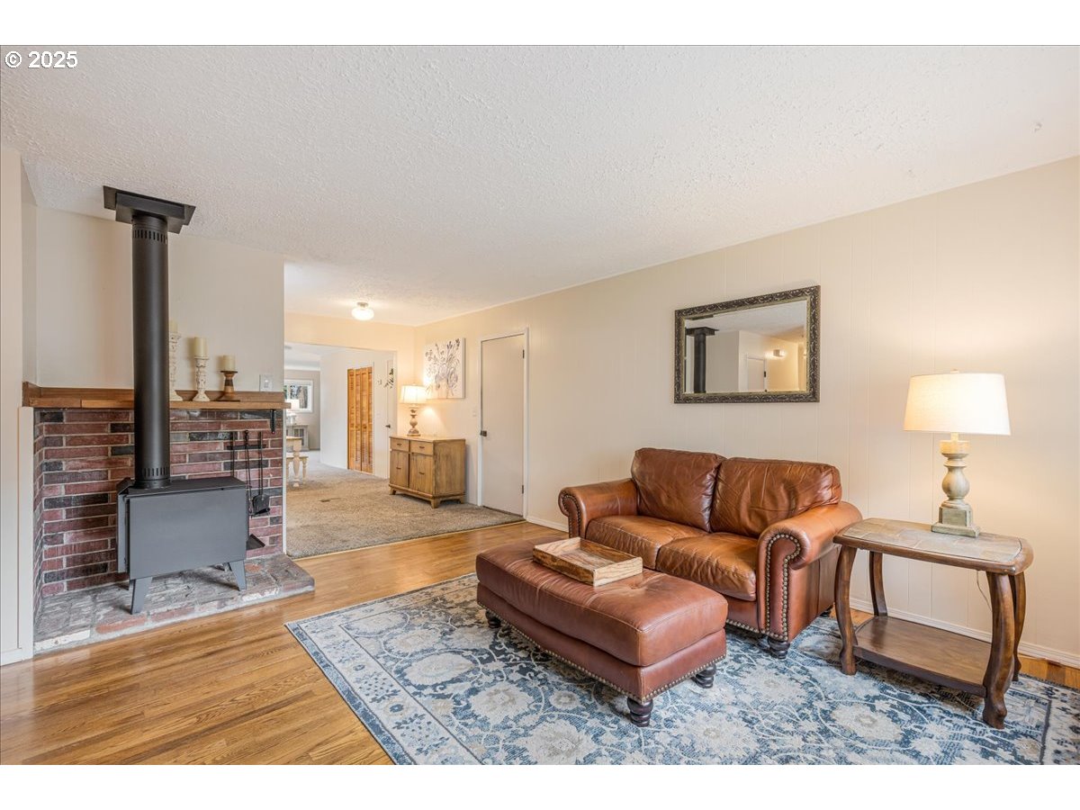 2604 Southeast 176th Place Portland, OR 97236 - Photo 5 of 27 a living room with furniture and a lamp