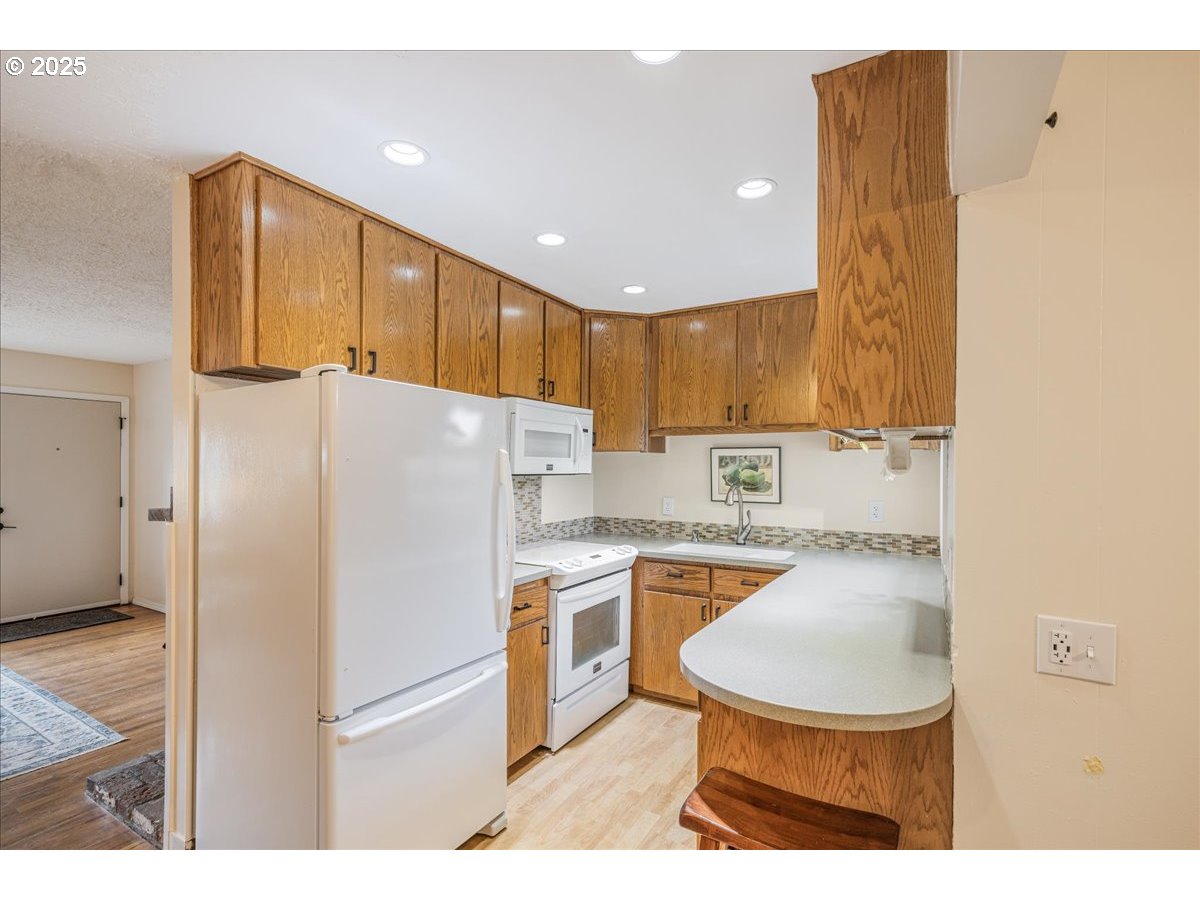 2604 Southeast 176th Place Portland, OR 97236 - Photo 6 of 27 a kitchen with stainless steel appliances granite countertop a refrigerator a stove and a sink