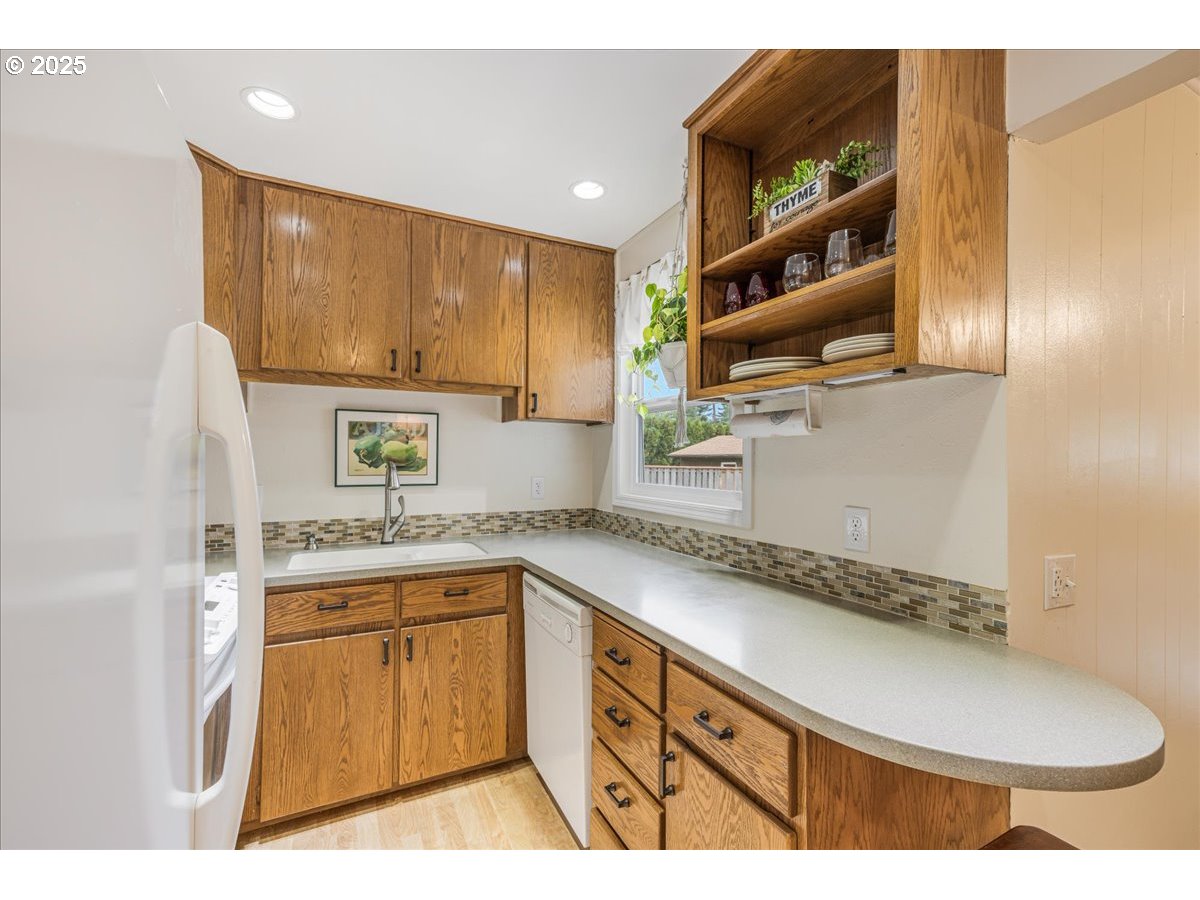 2604 Southeast 176th Place Portland, OR 97236 - Photo 7 of 27 a kitchen with a sink cabinets and window