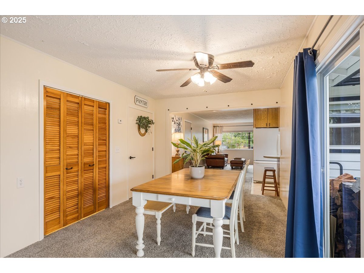 2604 Southeast 176th Place Portland, OR 97236 - Photo 9 of 27 a view of a dining room with furniture and a chandelier fan