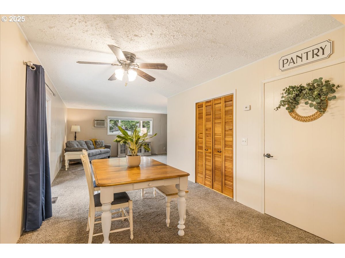 2604 Southeast 176th Place Portland, OR 97236 - Photo 10 of 27 a view of a dining room with furniture and a chandelier fan