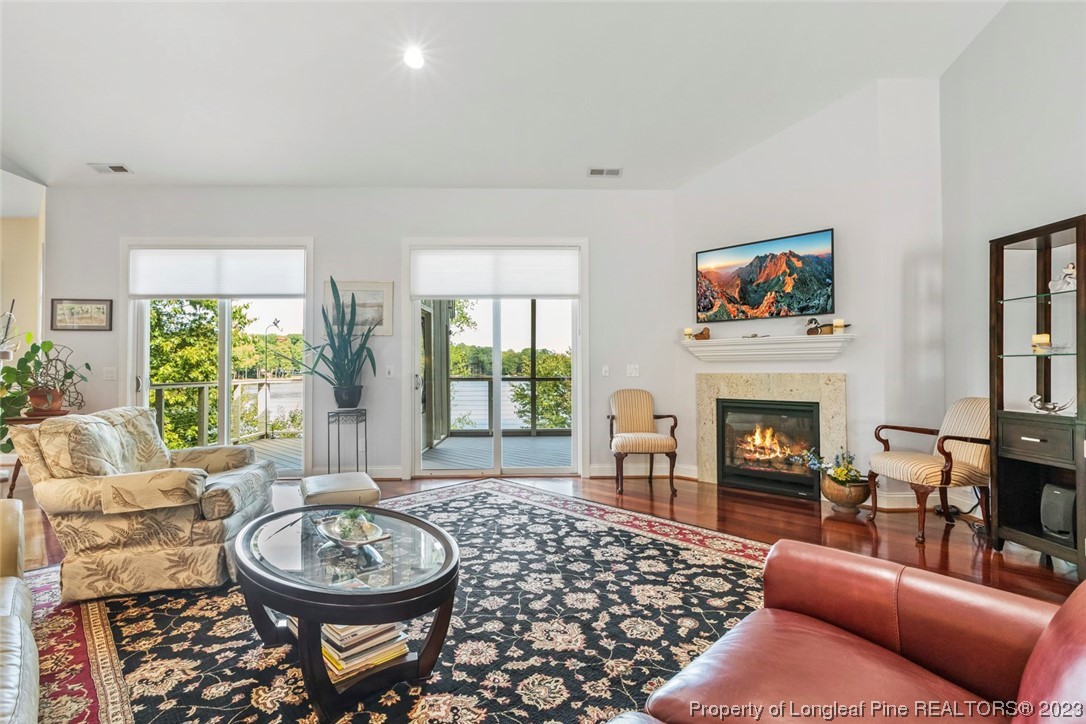 4 The Pointe Sanford, NC 27332 - Photo 12 of 50 a living room with furniture a fireplace a large window and a fireplace