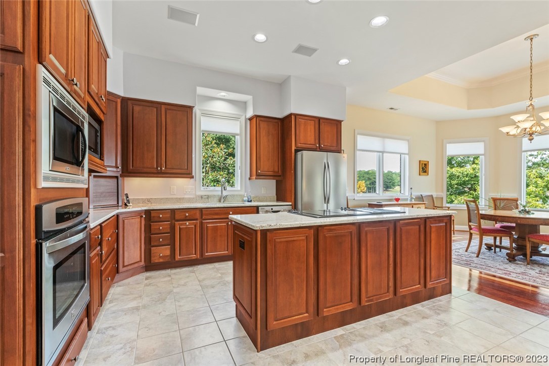 4 The Pointe Sanford, NC 27332 - Photo 16 of 50 a kitchen with stainless steel appliances granite countertop a stove top oven a sink dishwasher and a refrigerator