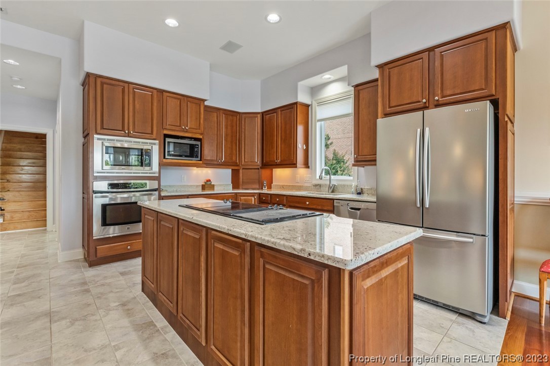 4 The Pointe Sanford, NC 27332 - Photo 18 of 50 a kitchen with stainless steel appliances granite countertop a refrigerator a sink and a stove