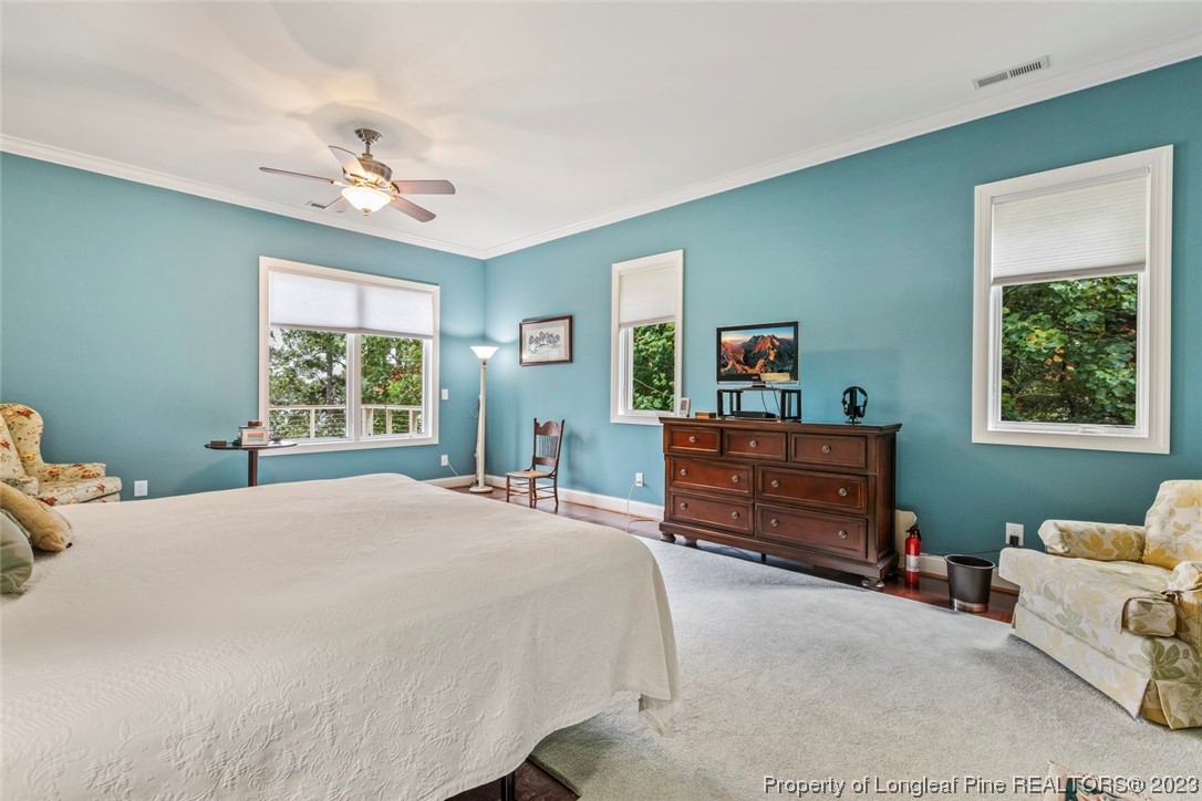 4 The Pointe Sanford, NC 27332 - Photo 27 of 50 a bedroom with a bed and furniture on the dresser