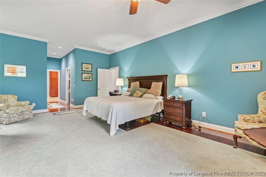 4 The Pointe Sanford, NC 27332 - Photo 28 of 50 a bedroom with a bed a table and painting on the wall