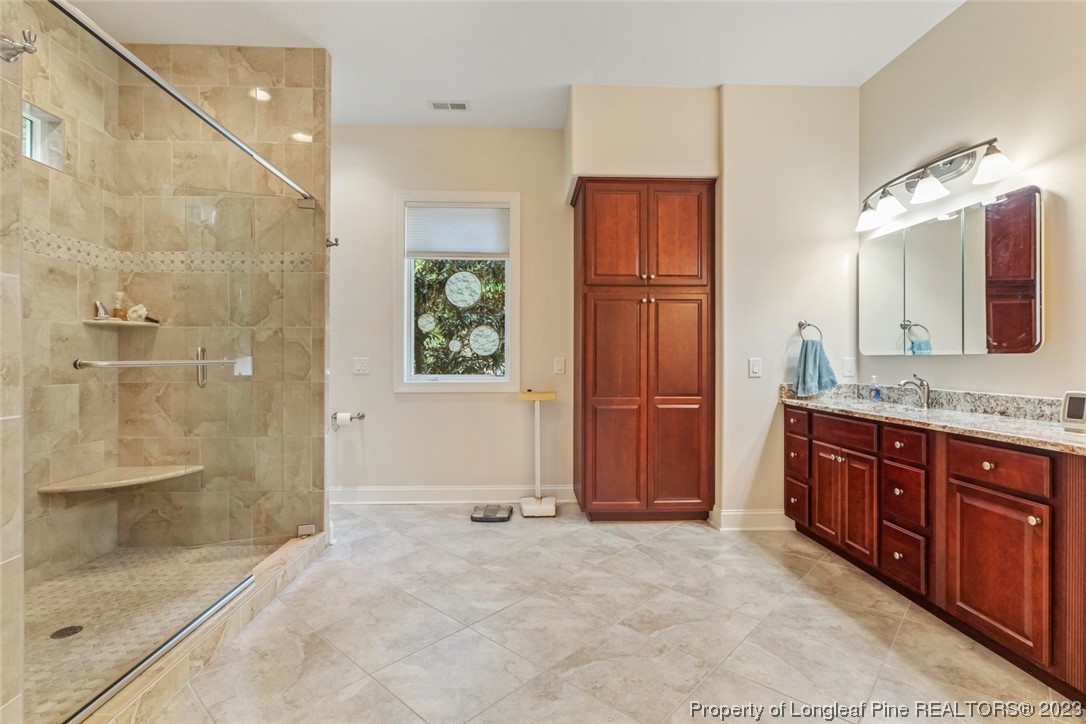 4 The Pointe Sanford, NC 27332 - Photo 29 of 50 a bathroom with a granite countertop sink mirror and shower