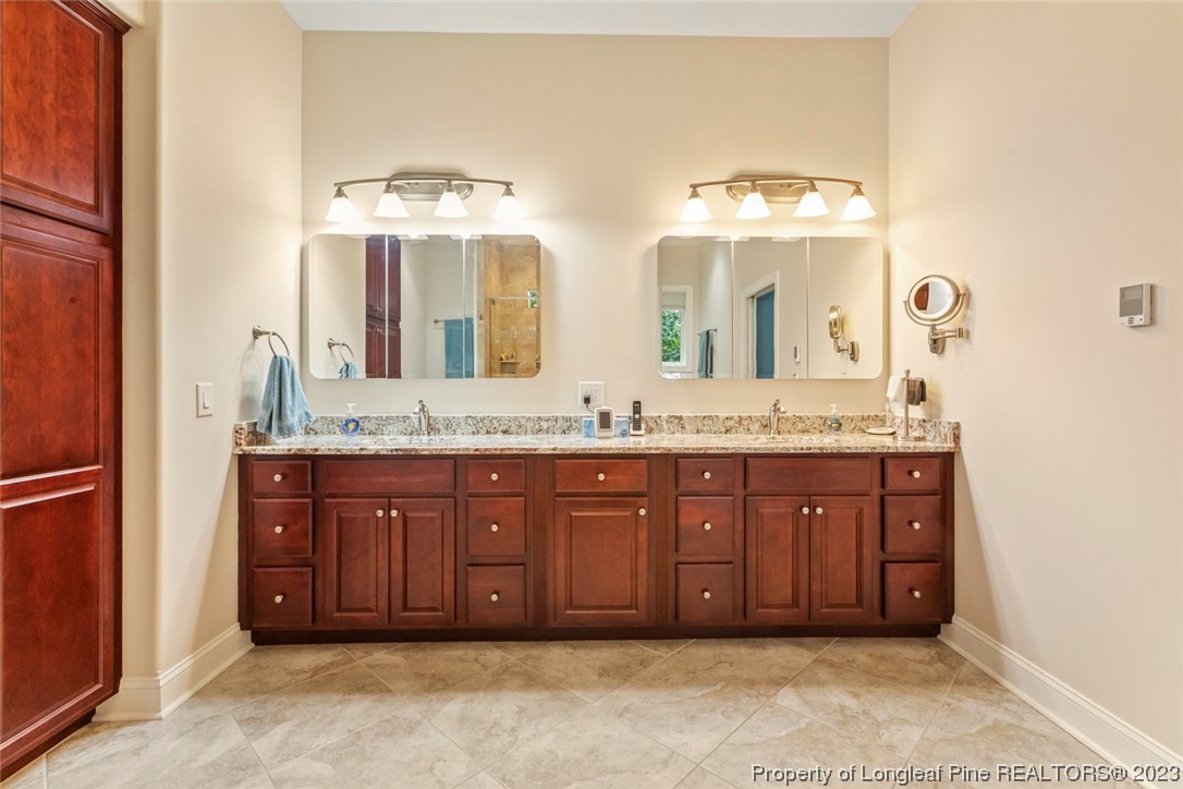 4 The Pointe Sanford, NC 27332 - Photo 30 of 50 a bathroom with a granite countertop sink and a mirror