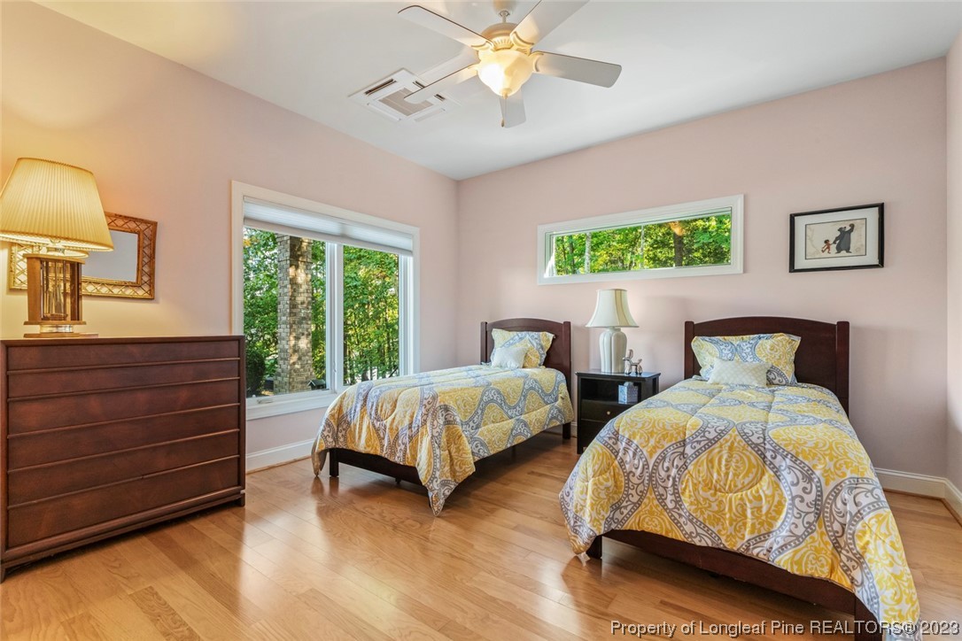 4 The Pointe Sanford, NC 27332 - Photo 36 of 50 a bedroom with two beds and a chandelier