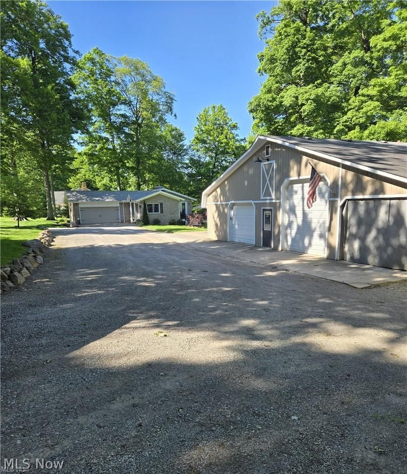 13725 Rockhaven Road Newbury, OH 44065 - Photo 23 of 31 40X50 with heat, second floor, concrete floors and 11 ft high overhead doors. Has 2 additional lean tos