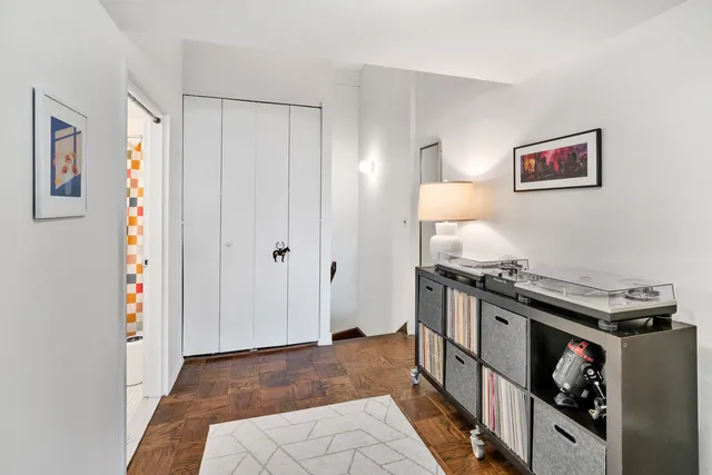 a bedroom with a bed and a painting on the wall