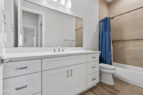 a bedroom with a bed and a night stand